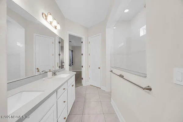 a bath room with a toilet a sink and a mirror