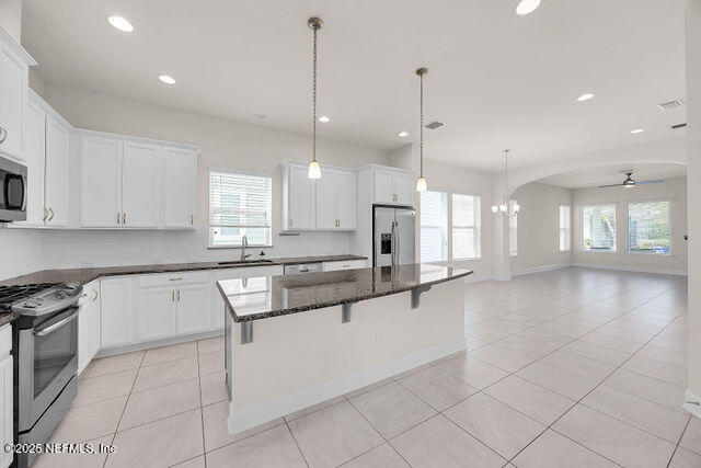 61 Spindrift Court St. Augustine, FL 32092 - Photo 31 of 61 a large kitchen with granite countertop a stove a sink a counter space and cabinets