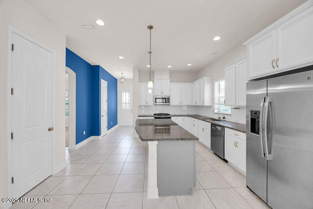 61 Spindrift Court St. Augustine, FL 32092 - Photo 33 of 61 a kitchen with a sink a counter top space stainless steel appliances and cabinets