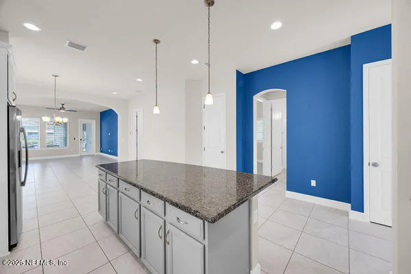 a kitchen with stainless steel appliances granite countertop a stove and a refrigerator