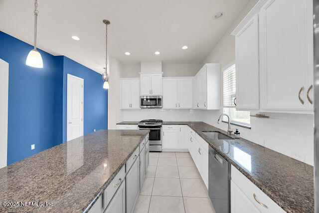 61 Spindrift Court St. Augustine, FL 32092 - Photo 35 of 61 a large kitchen with stainless steel appliances granite countertop a sink a stove and a refrigerator