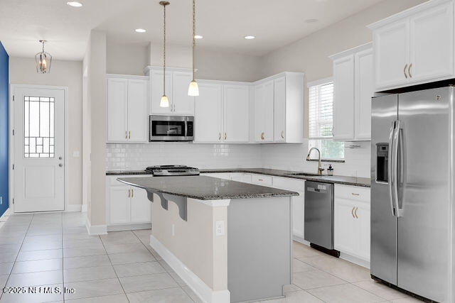 61 Spindrift Court St. Augustine, FL 32092 - Photo 42 of 61 a kitchen with stainless steel appliances granite countertop a stove and a refrigerator