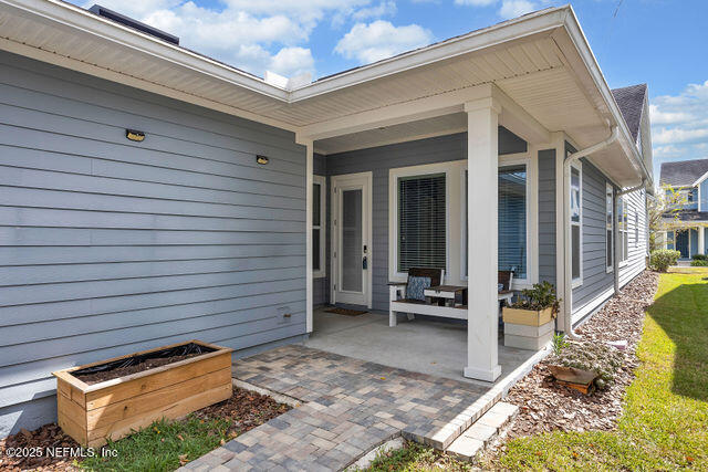 61 Spindrift Court St. Augustine, FL 32092 - Photo 51 of 61 a view of a patio with table and chairs with wooden floor and fence