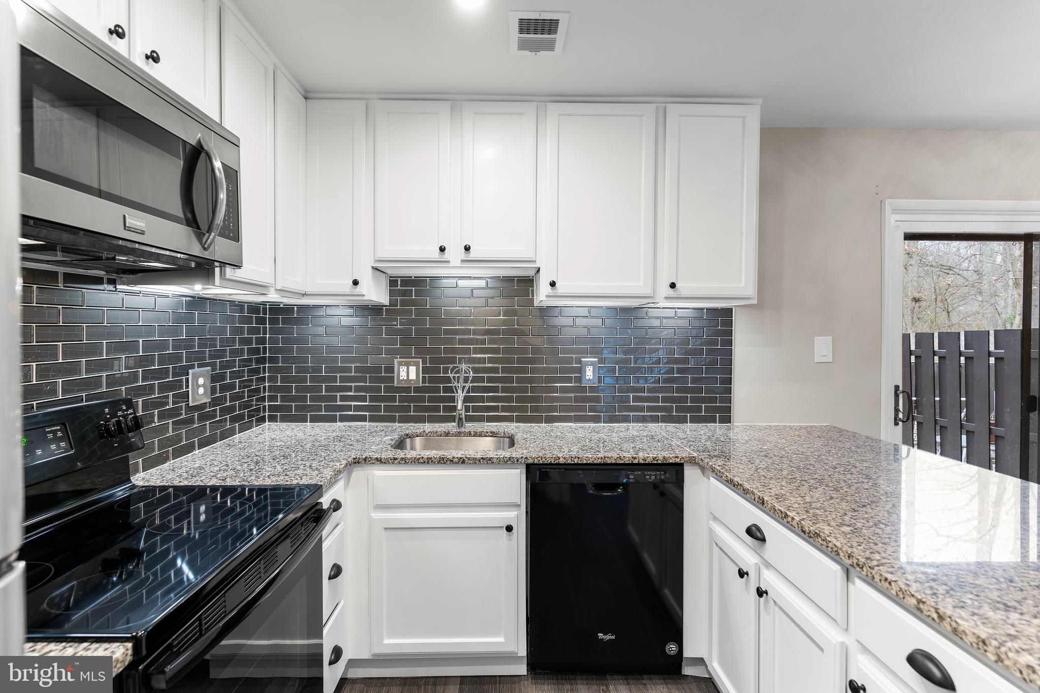 2138 Cartwright Place Reston, VA 20191 - Photo 8 of 27 Under cabinet lighting and glass tile backsplash