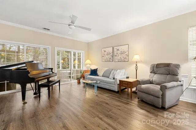 a living room with furniture and a wooden floor
