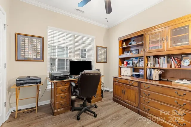 a view of a workspace with furniture and a window