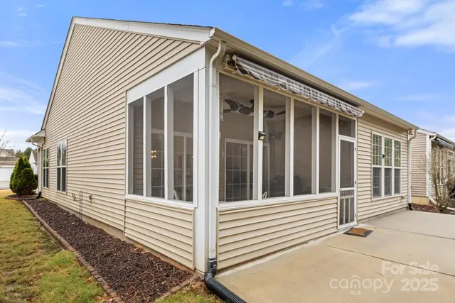 a view of a house with wooden fence