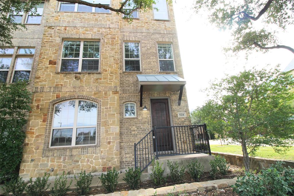View of front facade with stone siding and brick siding