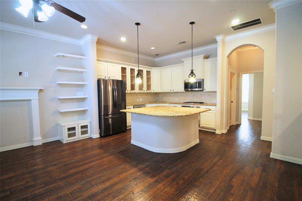 528 Tuscan Drive Irving, TX 75039 - Photo 11 of 40 a large kitchen with kitchen island a stove a refrigerator wooden floor and a view of living room