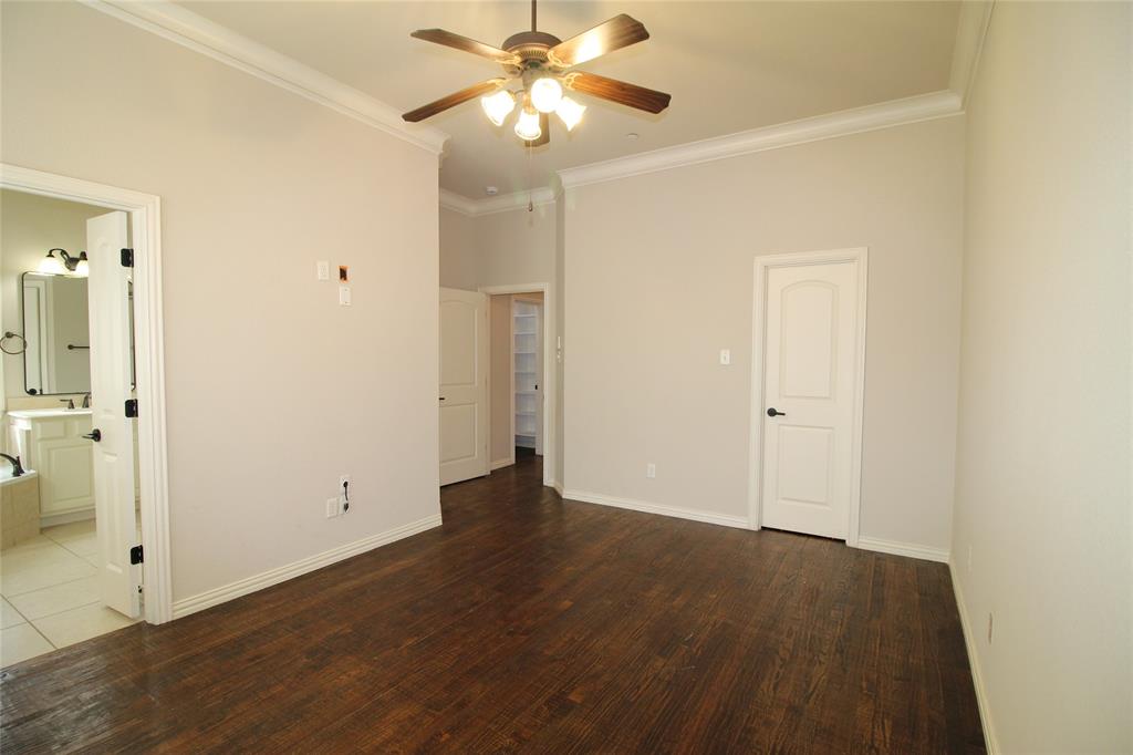 528 Tuscan Drive Irving, TX 75039 - Photo 18 of 40 an empty room with wooden floor and a ceiling fan