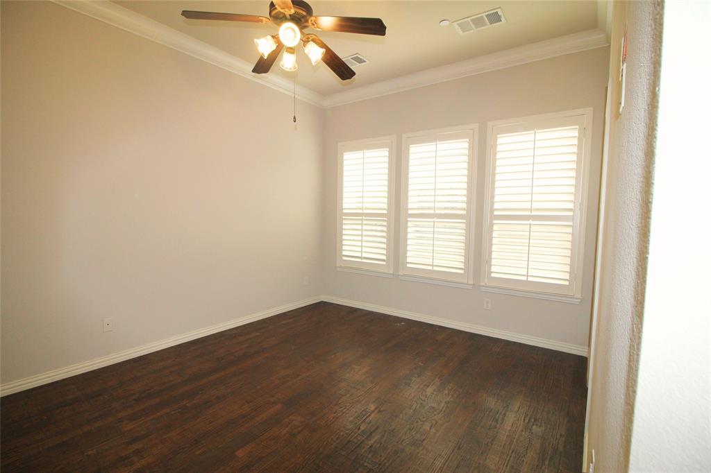 528 Tuscan Drive Irving, TX 75039 - Photo 20 of 40 a view of an empty room with wooden floor and a window