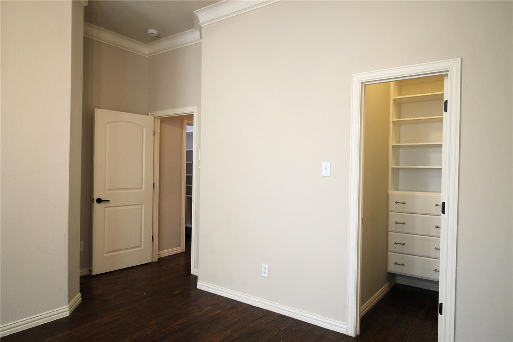 528 Tuscan Drive Irving, TX 75039 - Photo 23 of 40 a view of walk in closet with wooden floor