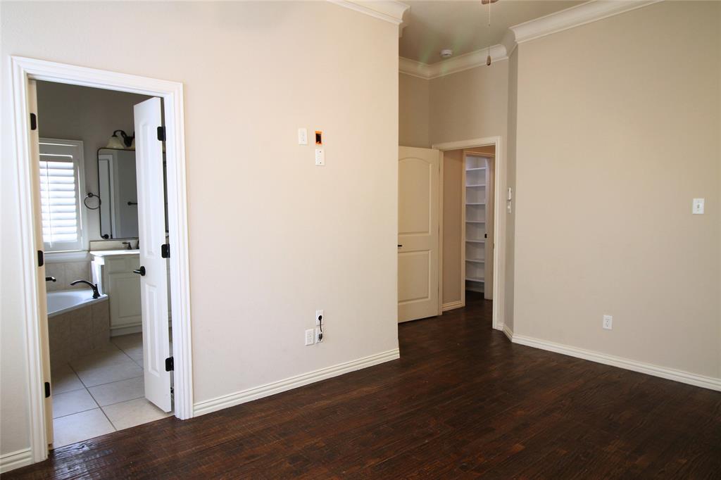 528 Tuscan Drive Irving, TX 75039 - Photo 24 of 40 Unfurnished room featuring dark wood-style flooring and crown molding