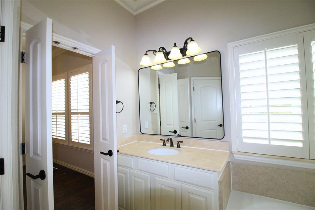 528 Tuscan Drive Irving, TX 75039 - Photo 25 of 40 a bathroom with a double vanity sink and a mirror