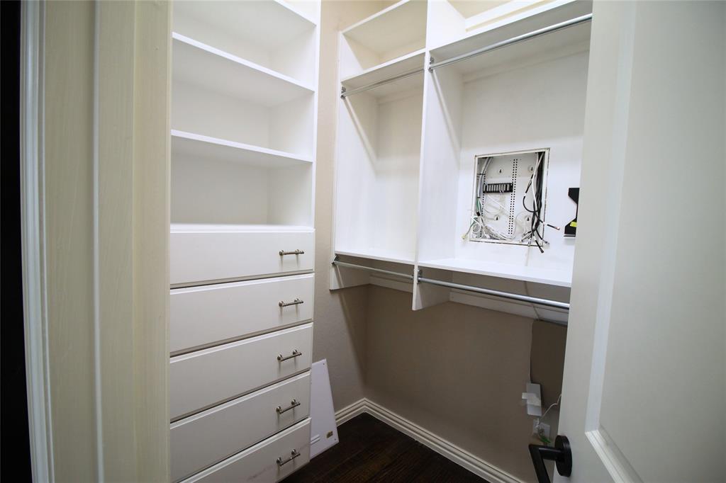 528 Tuscan Drive Irving, TX 75039 - Photo 27 of 40 Walk in closet with dark wood-style floors