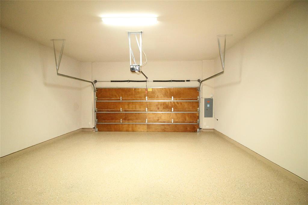 528 Tuscan Drive Irving, TX 75039 - Photo 38 of 40 Garage featuring electric panel and a garage door opener