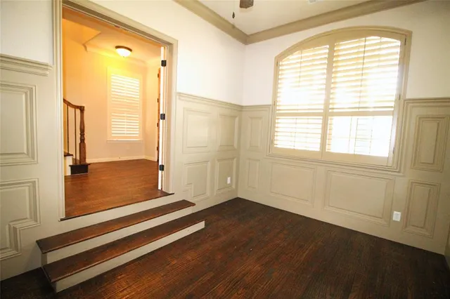 a view of a kitchen with a sink and dishwasher with wooden floor