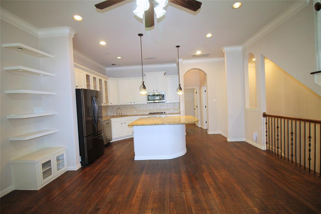 528 Tuscan Drive Irving, TX 75039 - Photo 10 of 40 a large kitchen with kitchen island a large counter top space a sink stainless steel appliances and cabinets