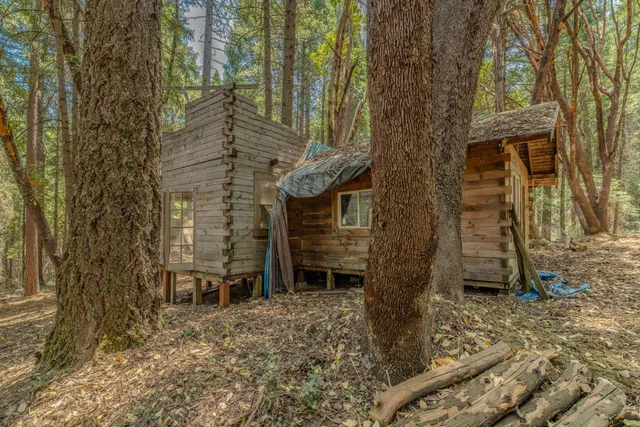 a backyard of a house with barbeque oven and outdoor seating