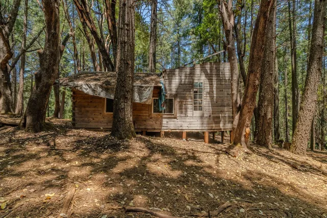a backyard of a house with table and chairs