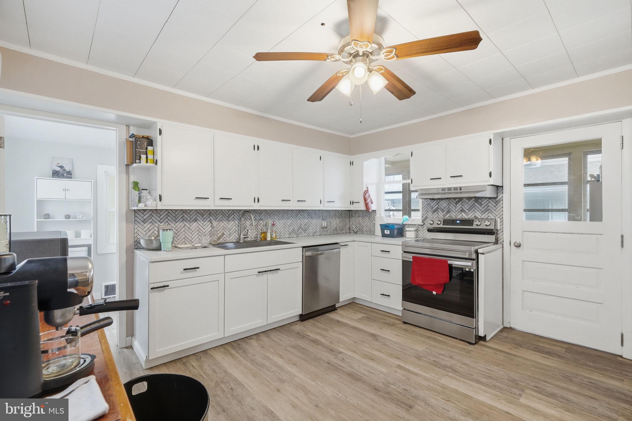 108 New Holland Avenue Reading, PA 19607 - Photo 13 of 66 a kitchen with stainless steel appliances a stove cabinets and wooden floor