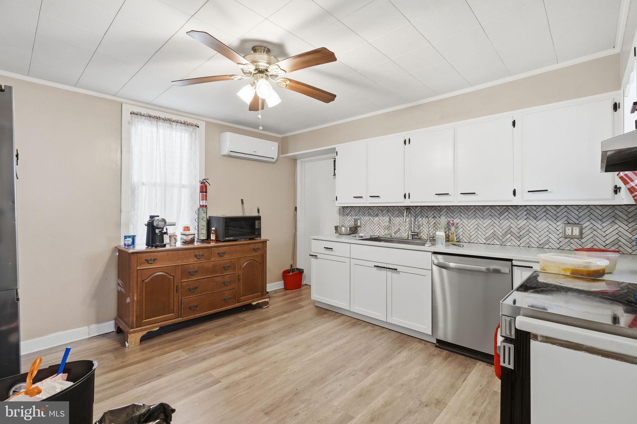 108 New Holland Avenue Reading, PA 19607 - Photo 41 of 66 a kitchen with stainless steel appliances granite countertop a sink a stove a refrigerator cabinets and wooden floor