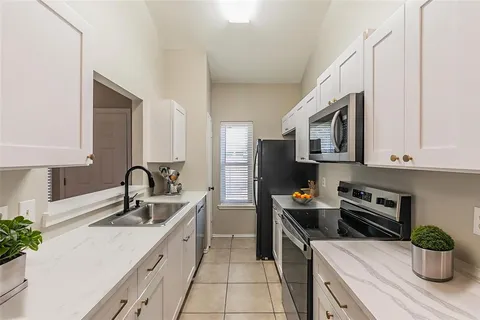 a kitchen with stainless steel appliances a sink dishwasher stove refrigerator and microwave