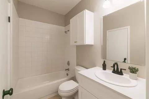 a bathroom with a toilet a sink and a bathtub