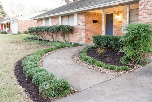 a front view of a house with garden