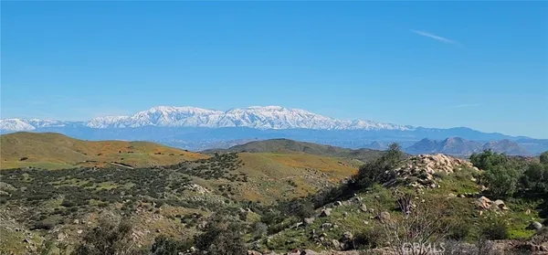 a view of a mountain range in a cloudy sky