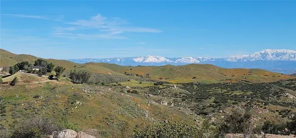 a view of a mountain range in a cloudy sky