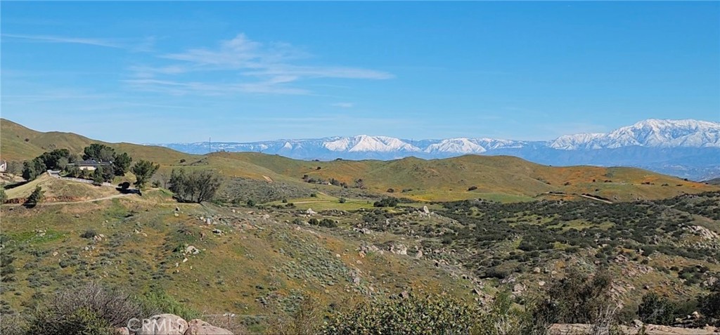 23250 El Nido Road Perris, CA 92570 - Photo 22 of 23 a view of a mountain range in a cloudy sky