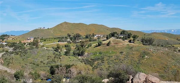 a view of a mountain range with a lush green hillside