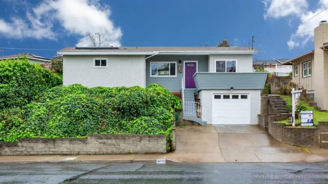 a front view of a house with a garden