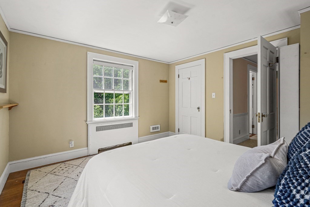 36 Laurel Avenue Wellesley, MA 02481 - Photo 18 of 27 a bedroom with a large bed and a window