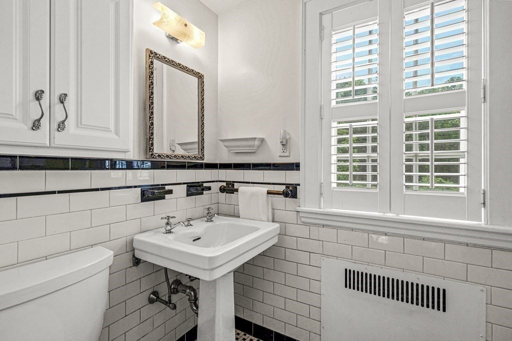 36 Laurel Avenue Wellesley, MA 02481 - Photo 19 of 27 a bathroom with a sink a toilet and a mirror