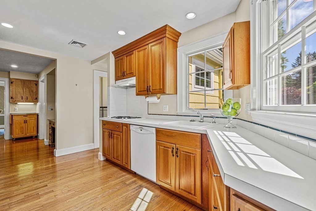 36 Laurel Avenue Wellesley, MA 02481 - Photo 8 of 27 a kitchen with stainless steel appliances granite countertop wooden cabinets a sink and a large window