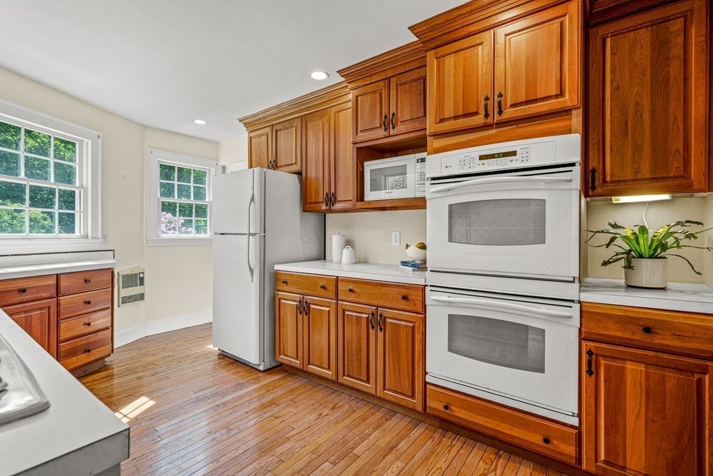 36 Laurel Avenue Wellesley, MA 02481 - Photo 9 of 27 a kitchen with stainless steel appliances granite countertop wooden cabinets a stove a sink and dishwasher