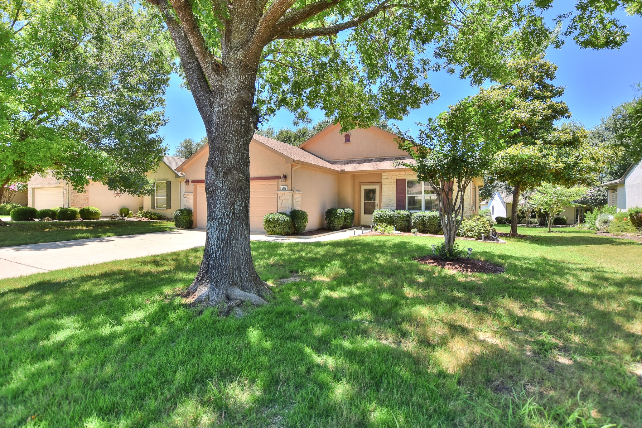 508 Texas Drive Georgetown, TX 78633 - Photo 2 of 14 A well-maintained lawn and mature trees frame this inviting single-story residence.
