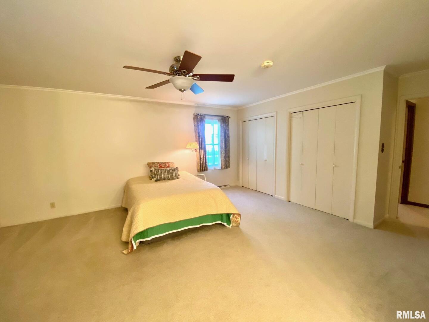 807 West Market Street Christopher, IL 62822 - Photo 23 of 57 a bedroom with a bed and a ceiling fan