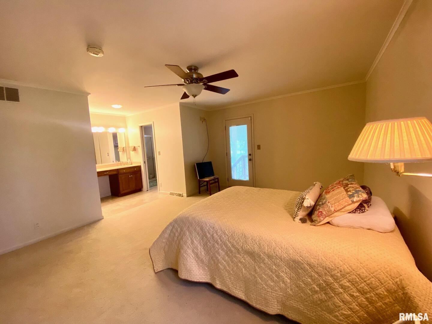807 West Market Street Christopher, IL 62822 - Photo 24 of 57 a bedroom with a bed ceiling fan and a wooden floor