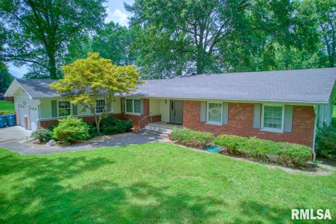807 West Market Street Christopher, IL 62822 - Photo 43 of 57 a front view of a house with a garden and trees