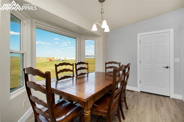 29850 Big Springs Road Calhan, CO 80808 - Photo 11 of 16 These Champion windows are easy to care for and maintain, offer beauty and plenty of sunshine. The dining area in the kitchen is large enough for a large dining table and 6 chairs. The soft paint schemes for the walls, trim, doors and cabinet are perfect for this custom built rancher on the high plains.
