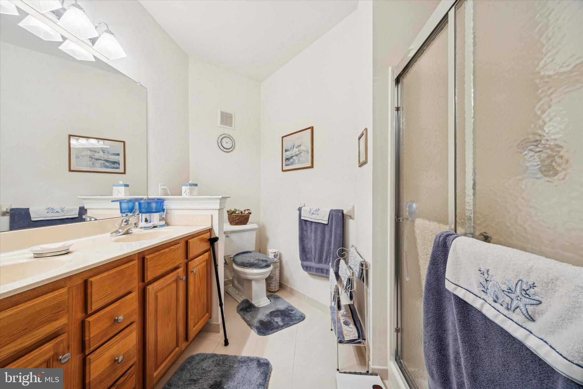 3000 Village Way, Unit 3101 Boothwyn, PA 19061 - Photo 11 of 29 a bathroom with a sink a toilet and mirror