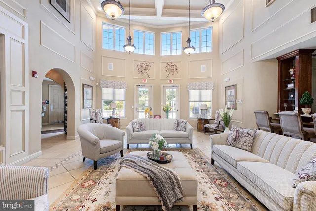 a living room with fireplace furniture and a rug