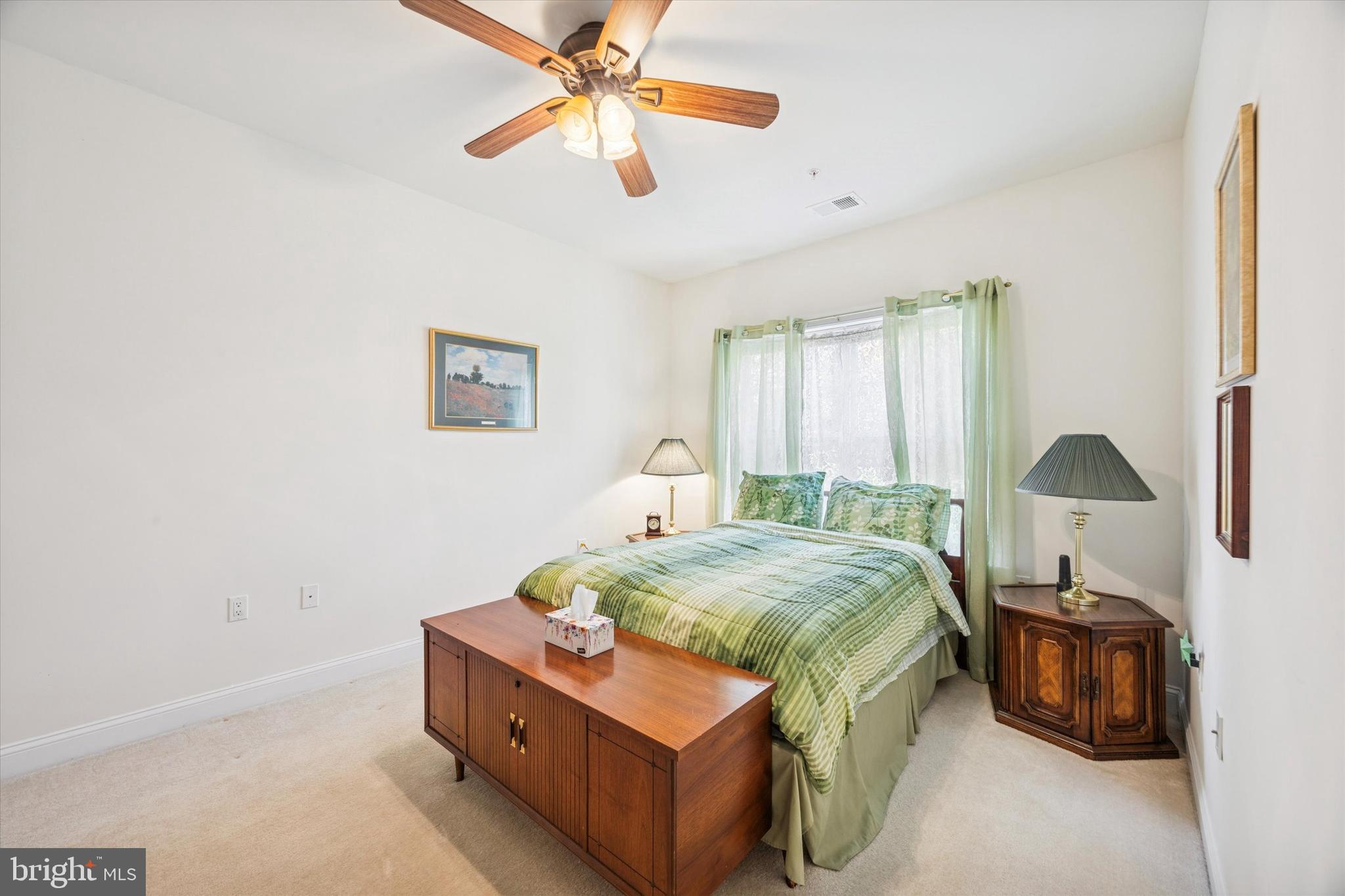 3000 Village Way, Unit 3101 Boothwyn, PA 19061 - Photo 9 of 29 a bed room with a bed and a chandelier