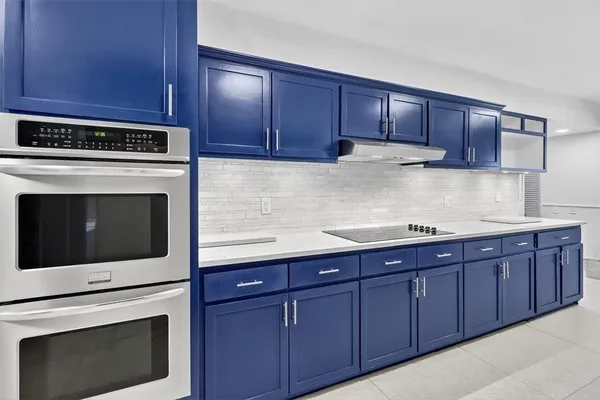 a kitchen with granite countertop wooden cabinets and stainless steel appliances