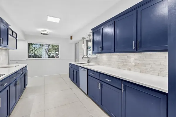 a kitchen with stainless steel appliances granite countertop wooden cabinets a sink and dishwasher