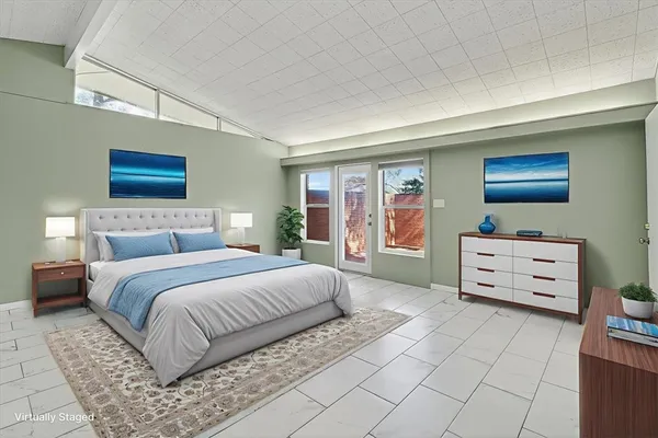 a bedroom with a bed and a dresser in it