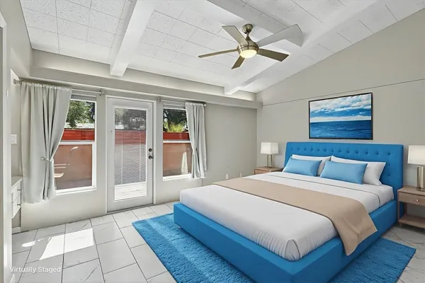 a bedroom with a large bed and a chandelier